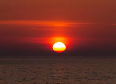 The Sun Sets Below the Horizon Stock Photos
