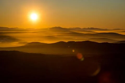 The sun sets below the horizon Stock Photos