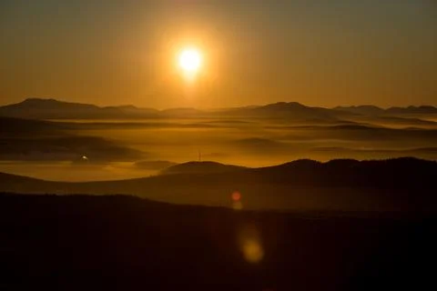 The sun sets below the horizon Stock Photos