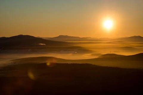 The sun sets below the horizon Stock Photos