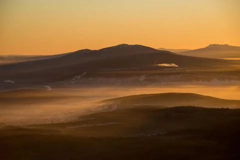 The sun sets below the horizon Stock Photos