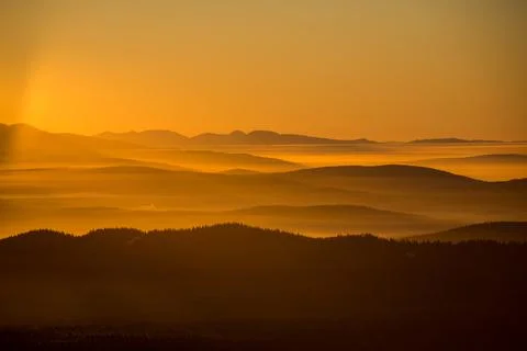 The sun sets below the horizon Stock Photos