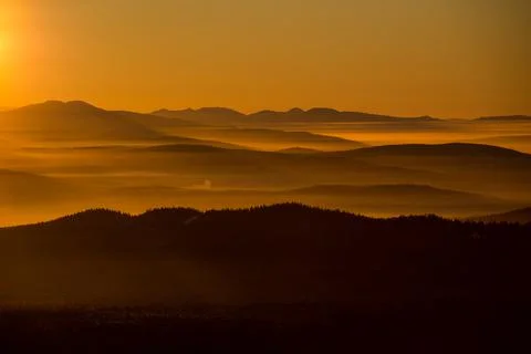 The sun sets below the horizon Stock Photos