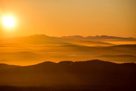 The sun sets below the horizon Stock Photos