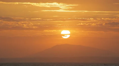 The sun sets directly to the mountain peak. Spectacular sky. Stock Footage 45298531
