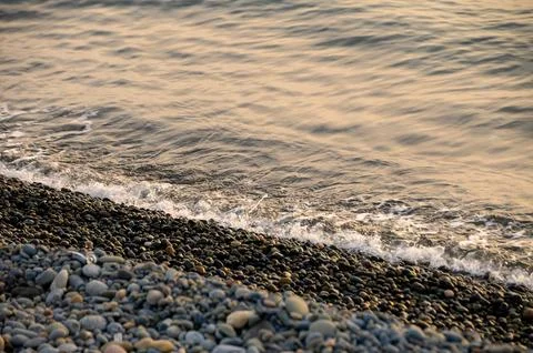 Sun sets on a dramatic cloudy sky over the Mediterranean Sea horizon with a.. Stock Photos