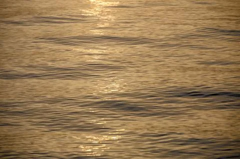 Sun sets on a dramatic cloudy sky over the Mediterranean Sea horizon with a.. Stock Photos