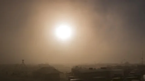 Sun sets during dust storm at desert festival 스톡 동영상 228005900