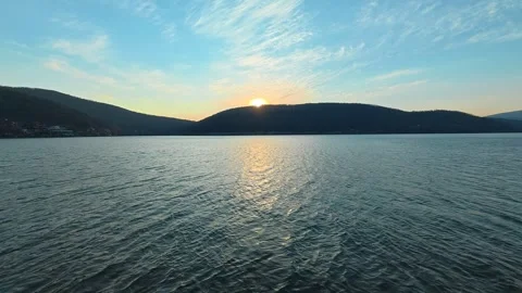 Sun sets gently over distant hills . Bovan Lake Video stock 330989340