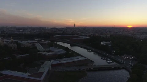 The sun sets on the horizon near the Peter and Paul Fortress in St. Petersburg Stock Footage 76845424