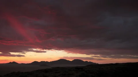SUN SETS LIGHTING UP DARK RED CLOUD UHD 4K Stock Footage 45345418