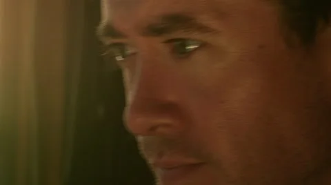 The Sun Sets On A Man Gathering His Thoughts Next To An Open Window. Stock Footage 50954780