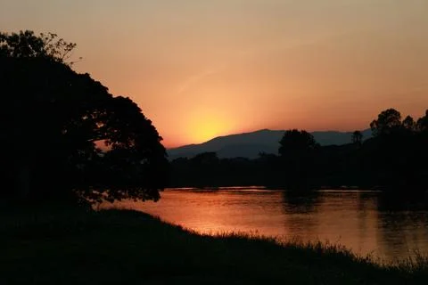 Sun sets with mountain and river Stock Photos