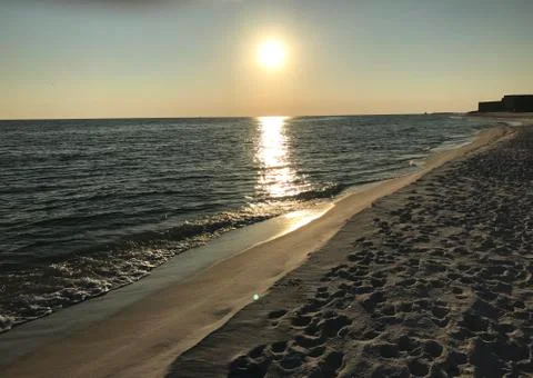 Sun sets over the beach Stock Photos
