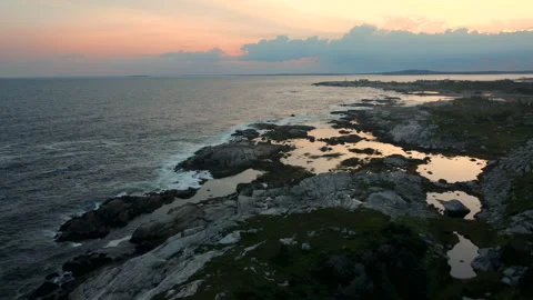 Sun sets over the coastline near Peggy's Cove, Nova Scotia Stock Footage 214423908