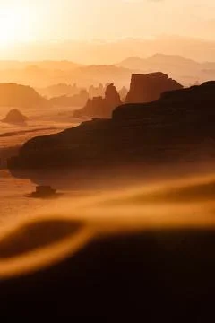 The sun sets over a desert landscape Stock Photos