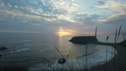 Sun sets over Goat Rock Beach on the rugged California coast Stock Footage 327700623