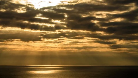 The Sun Sets Over The Gulf of Mexico Timelapse Golden Clouds make Rays Stock Footage 94315576