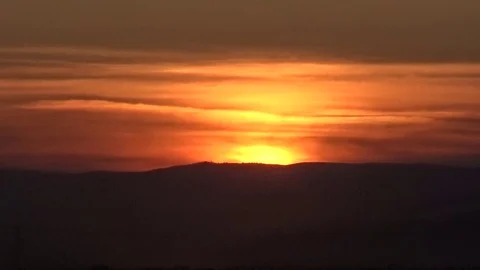 The sun sets over the hill, the red sunset Stock Footage 75555862