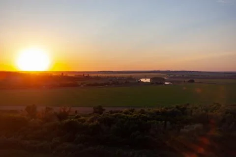 The sun sets over the horizon Stock Photos