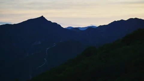 Sun sets over mountain in China with Great Wall tower Stock Footage 124997468