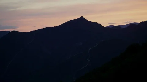 Sun sets over mountain in China with Great Wall tower Stock Footage 124997488