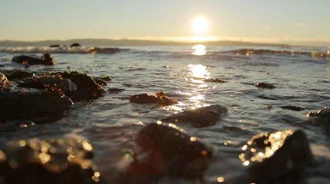 Sun Sets Over Ocean Waves On Beach Video stock 47003439