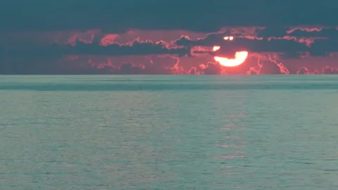 Sun sets over the sea in cloudy weather Stock Footage 94332146