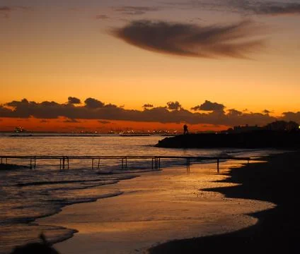 The sun sets over a serene beach in Cyprus Stock Photos
