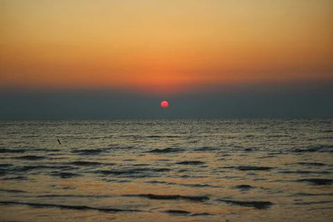 The sun sets over water Stock Photos