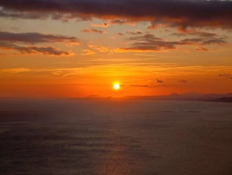 Sun Sets Peacefully, Beautiful Dusk Scene Showing Sun Disappearing Over Stock Photos