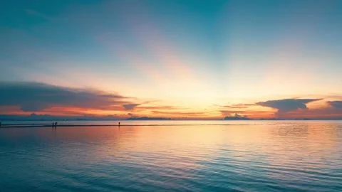 Sun sets in the sea. Colorful cloudy sky and sunbeams. Stock Footage 156006670
