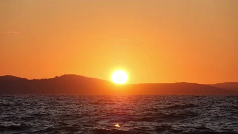 Sun sets into the sea. Waves and splashes shine in sunset light. Bright colors 스톡 동영상 125640527