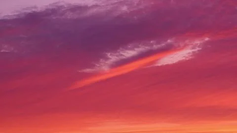 As the sun sets, the sky is filled with a warm and vibrant light. Stock Photos