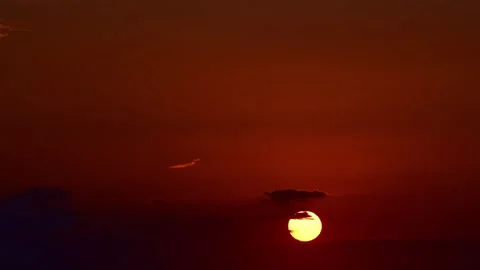 Sun sets through clouds in open sky timelapse Stock Footage 345162090