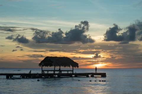 The sun sets in Tobago behind a dock Stock-Fotos
