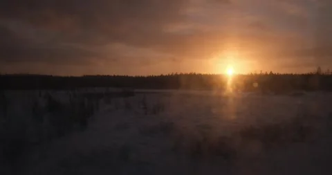 As the sun sets, the train's window frames a landscape of woods, their contours Video stock 254516488