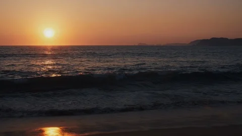 The Sun sets on a tropical sandy beach Stock Footage 119125697