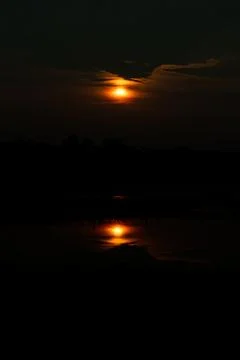 The sun sets under the water when you last see the sun in the sky Stock Photos