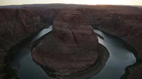 Sun setting above Horseshoe bend and Colorado river Stock Footage 146367631