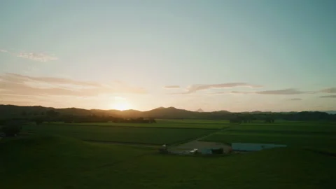 Sun setting across cane field farmlands and mountain ranges Stock Footage 153127419