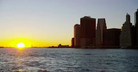 Sun setting along the East River with the Statue of Liberty in the background. Stock Footage 72993089