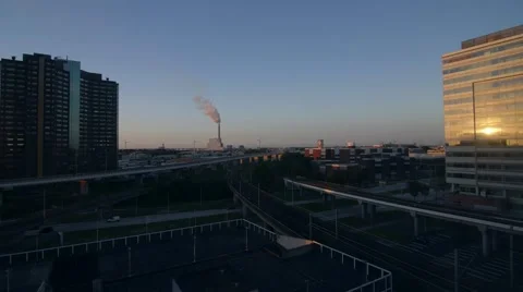Sun setting on Amsterdam building and busy intersection Stock-Footage 66777515