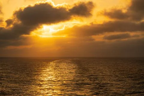 Sun setting off the back of a cruise ship off Alaska Stock Photos