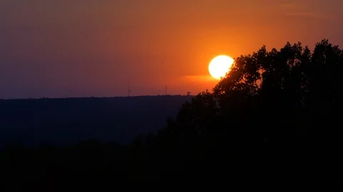 Sun Setting behind blowing trees in Cuyahoga Valley Stock Footage 87621567