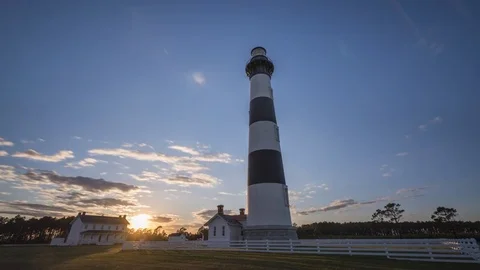 Sun setting behind Bodie Island Lighthouse in North Carolina Stock-Footage 74978409