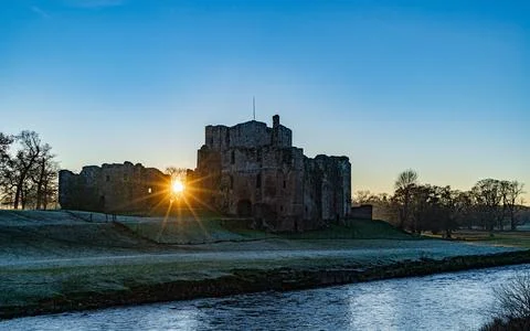 The Sun setting behind Brougham Castle on a frosty winters day Stock Photos