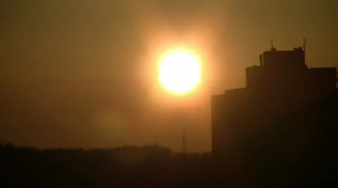 The sun is setting behind a building (High Definition) Stock-Footage 67612