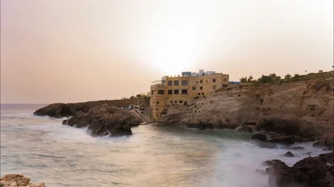 Sun setting behind the buildings at Ghar Lapsi, Siggiewi Malta with the 動画素材 133313483