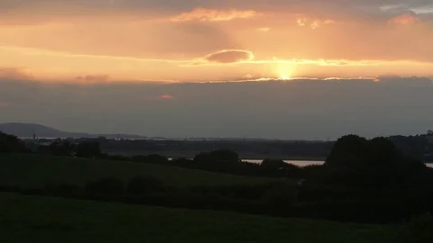 Sun setting behind clouds and fading to black Stock-Footage 73559210